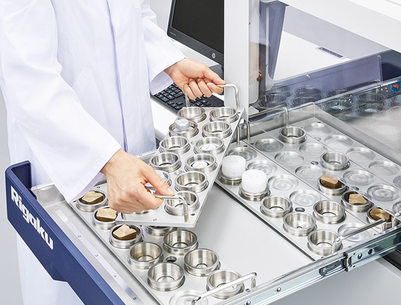 ZSX Primus IVi with scientist loading samples (closeup)