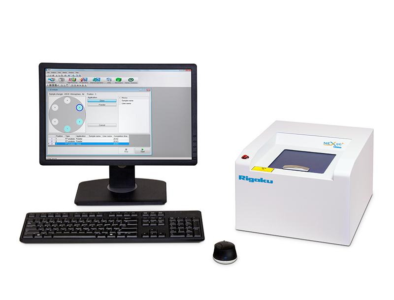 Rigaku NEX QC+ QuantEZ benchtop EDXRF elemental analyzer with a desktop computer.