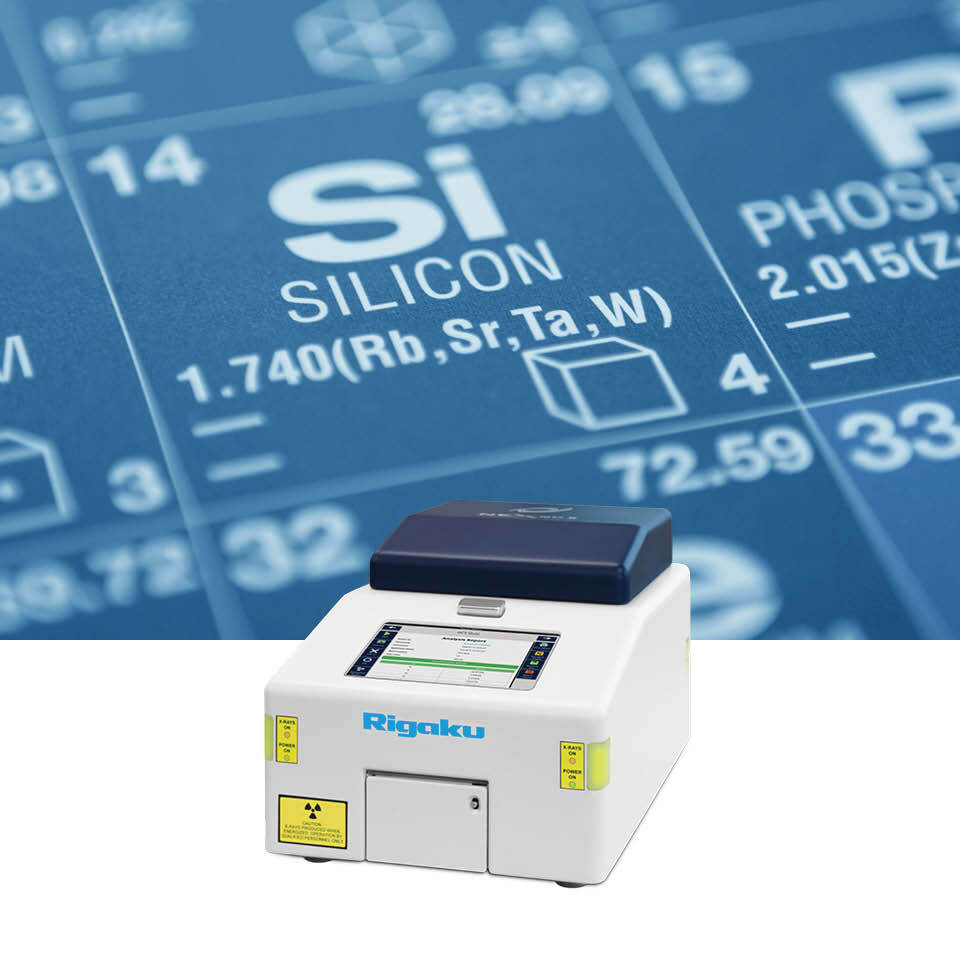 Silicon periodic element displayed alongside NEX QC II Series, an elemental analyzer, that measures silicone coat weight and metal catalysts.